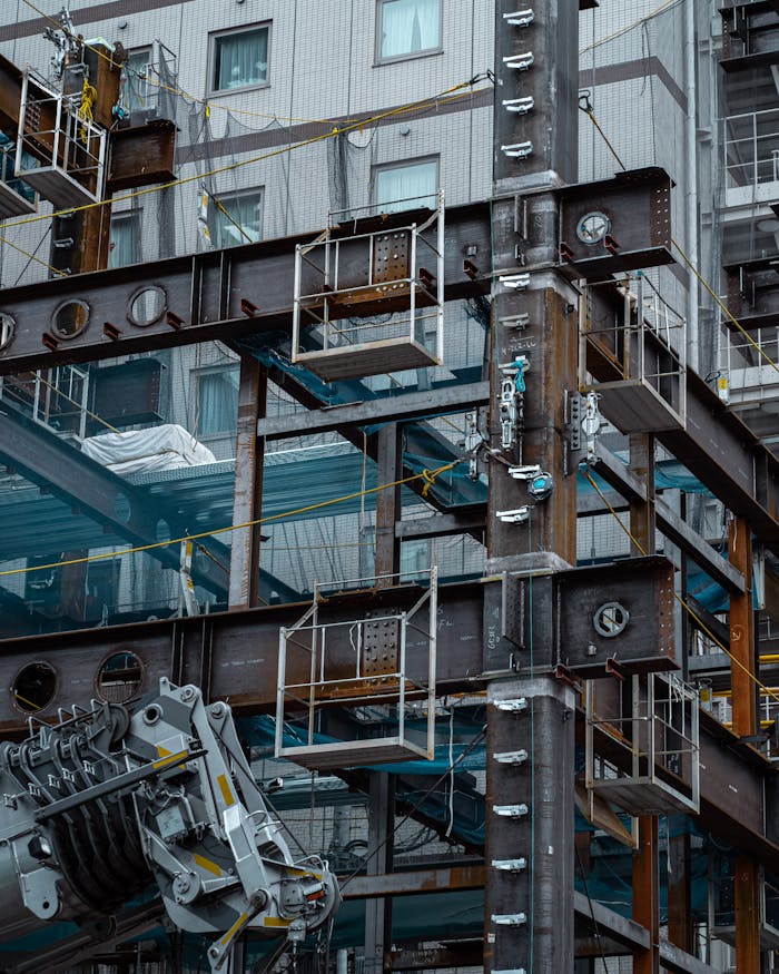 Detailed view of a Japanese construction site showcasing steel beams and modern architecture.